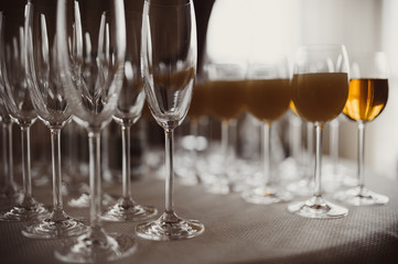 Glasses with alcohol and different drinks, glasses of wine and champagne are on the buffet table