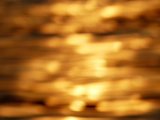 blur abstract golden reflection on water sunset