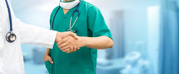 Doctors shaking hands. Medical people teamwork.