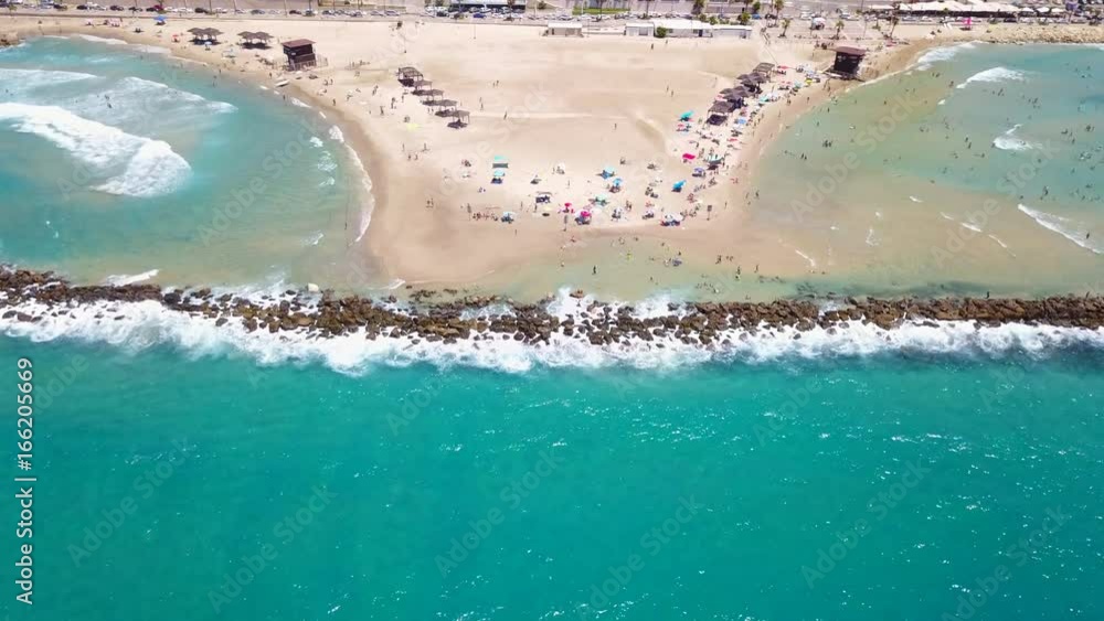 Wall mural tropical beach with colorful umbrellas - top down aerial view