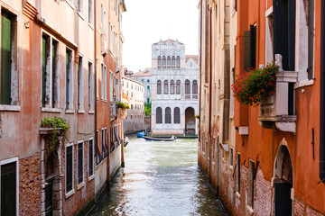 Narrow canal with gondolas in Venice, Italy