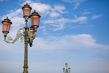 Fototapeta na wymiar Old street lamp against the blue sky