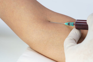 Doctor pricking needle syringe to collect blood for test the health Close up shot. Medical concept