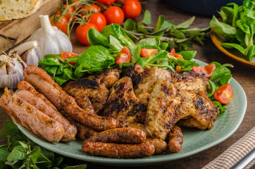 Grilled chicken wings and sausages