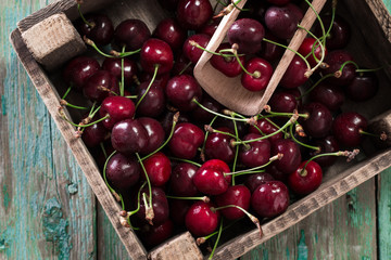 Cherries on wooden table with water drops macro background