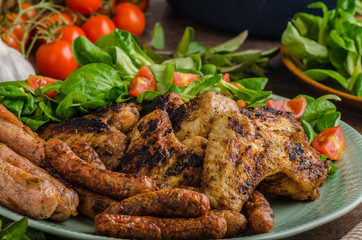 Grilled chicken wings and sausages