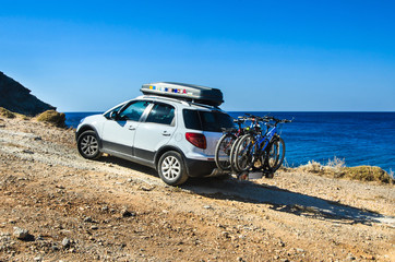 Car with roofbox and bicycle on the road