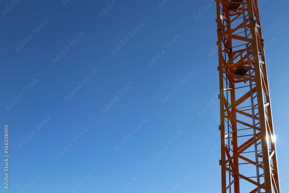 Wall mural construction crane against blue sky