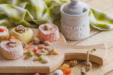 Fototapeta na wymiar Set of rahat lokum with candied peels, nuts and sugar powder