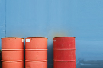 Naklejka premium Three red tank of fuel on blue background.