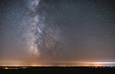 Naklejka na ściany i meble The center of our home galaxy, the Milky Way rising over the field, the night stars landscape