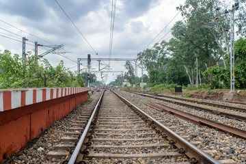 July 27, 2017. Train tracks of the Indian railways running through Purulia , West bengal, India. A passenger train is passing by.