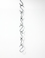 The small metal S hooks, hook of line, on white Background.