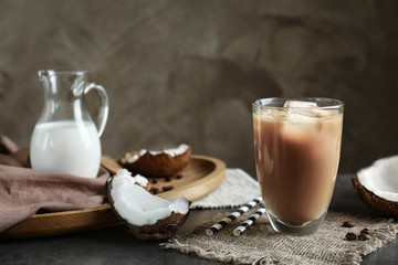 Glass of cold tasty coconut coffee on table