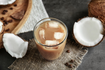 Glass of cold tasty coconut coffee on table