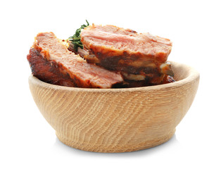 Juicy fried spare ribs in wooden bowl, isolated on white
