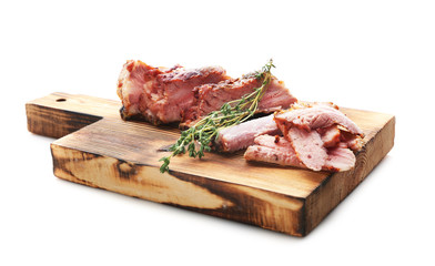 Wooden board with delicious sliced grilled spare ribs on white background