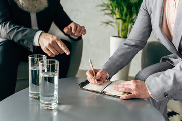 cropped view of hands of business colleagues having conversation in office