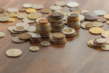 Different gold and silver collector's coins on the wooden table
