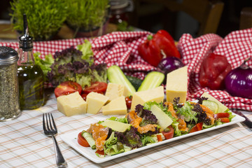 Salad with salmon, parmesan cheese, lettuce and rocket salad. Salad with fish.
