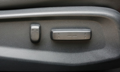 Buttons for adjusting seat position. Car interior detail.