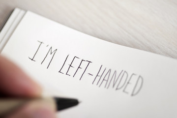 left-handed man writing the text I am left-handed