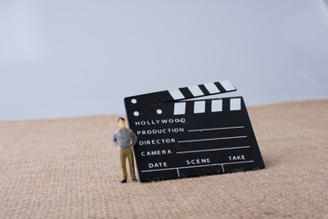 Movie  clapper and a man figurine