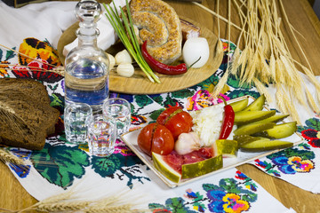 A plate of pickled cucumbers, tomatoes, garlic, cabbage and watermelon. Appetizer from pickles to vodka. Slavic traditional snack to vodka