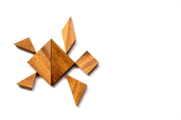 Wooden tangram puzzle in swimming turtle shape on white background