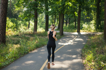 A young girl jogging in the park