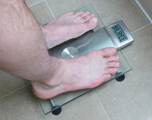 Man's feet on weight scale - Balance