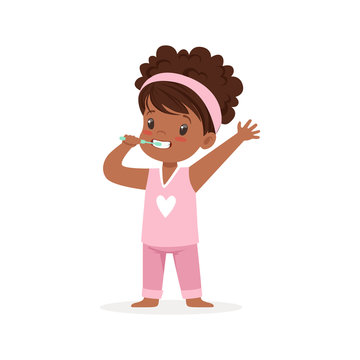 Adorable black cartoon girl in a pink pajamas brushing her teeth, kids dental care vector Illustration