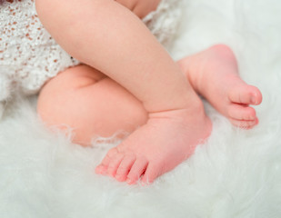 sweet baby legs folded on cot