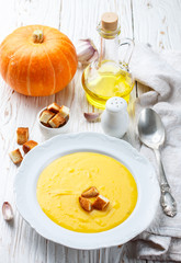 Homemade pumpkin cream soup with garlic croutons. A rustic style. Selective focus