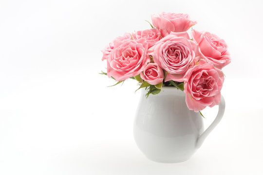 still life of pink rose in ceramic cup