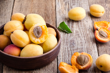 Ripe organic apricots on rustic wooden table