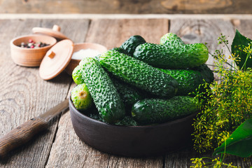 Ripe organic cucumbers on rustic wooden table