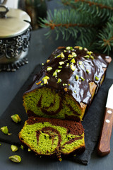 Chocolate pistachio cake with frosting.