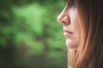Beautiful woman on green summer background