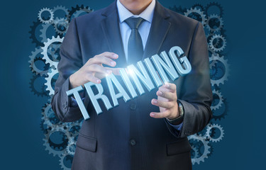 Businessman holding the word training .