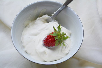 strawberries in cream for dessert , still life