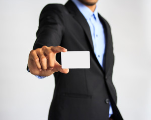 Man holding and showing blank plastic credit card with copy space  on white background.