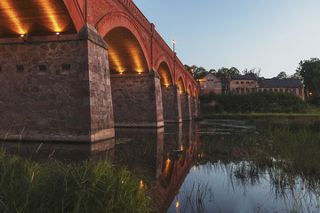 The old-fashioned Latvia.Kuldiga. ventas hub over the bridge at night