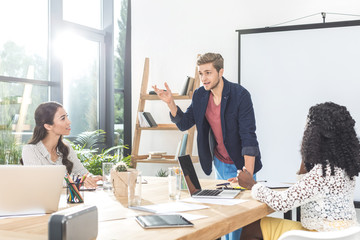 multiethinc business coworkers having conversation during conference in office