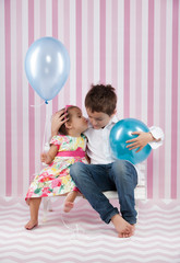 happy kids with a blue ballons in studio