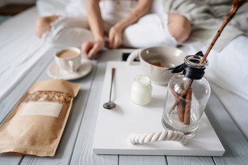 Woman eating cereals in bed