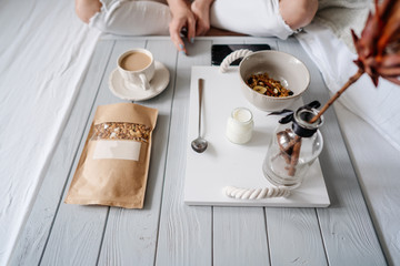 Woman eating cereals in bed