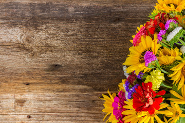 Bright bouquet with fresh fall flowers on wooden textured table with copy space
