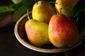 Plate with ripe pears. Low key. Selective focus