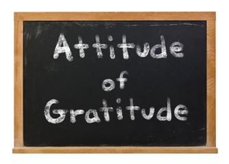 Obraz premium Attitude is Gratitude written in white chalk on a black chalkboard isolated on white